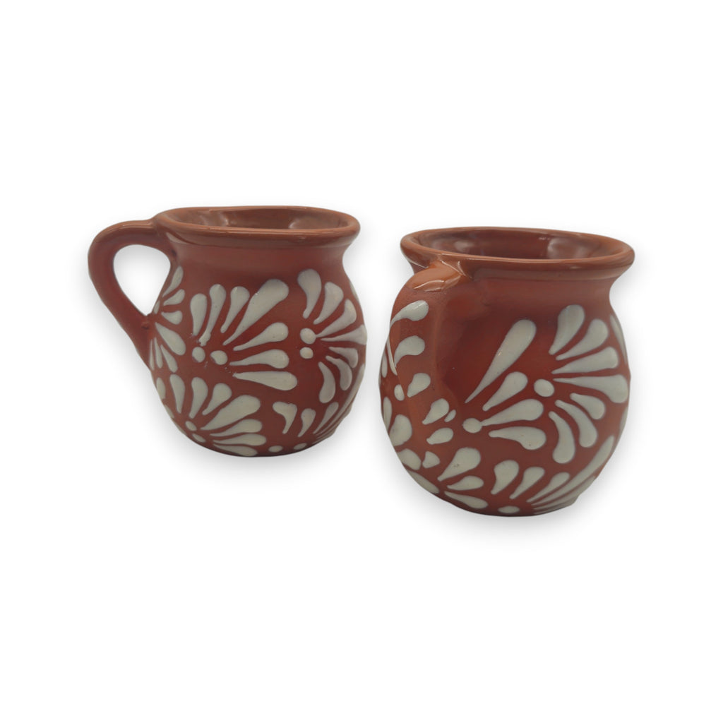Handmade Mexican Talavera mug with brown clay and vibrant patterns, showcasing traditional artisan pottery craftsmanship.