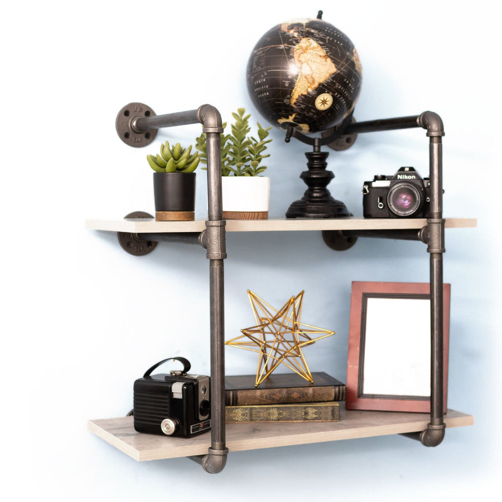 Two-tier wall-mounted shelf with black pipe decor brackets, showcasing a modern industrial style for home or office storage.