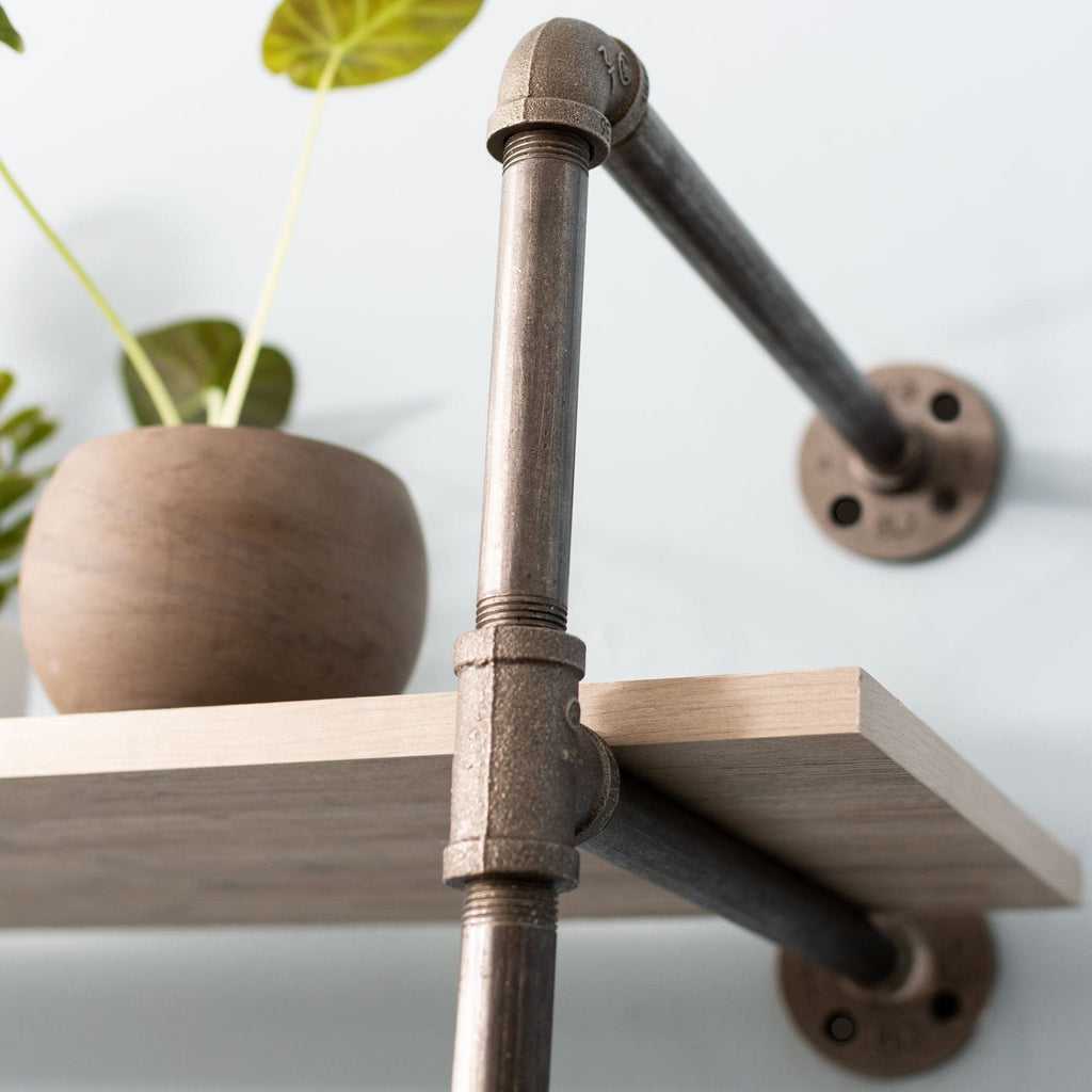 Wall-mounted 2-tier shelf with black metal pipe brackets from Pipe Decor, showcasing a modern industrial storage solution.