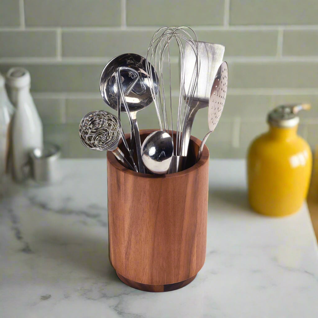Kalmar Home rotating lazy Susan utensil holder on a tabletop, featuring multiple compartments for organizing kitchen tools.