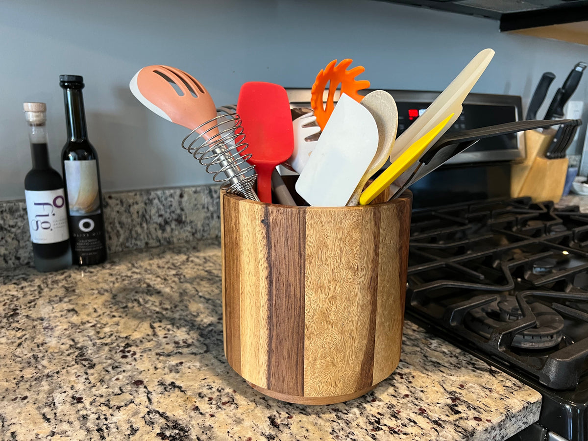 Rotating Kalmar Home Lazy Susan utensil holder on a tabletop, featuring multiple sections for organizing kitchen utensils.
