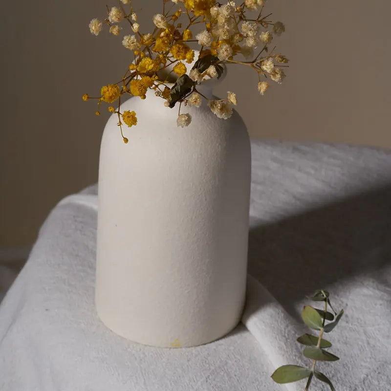 Simple ceramic vase with a smooth finish, ideal for home decor or floral arrangements.