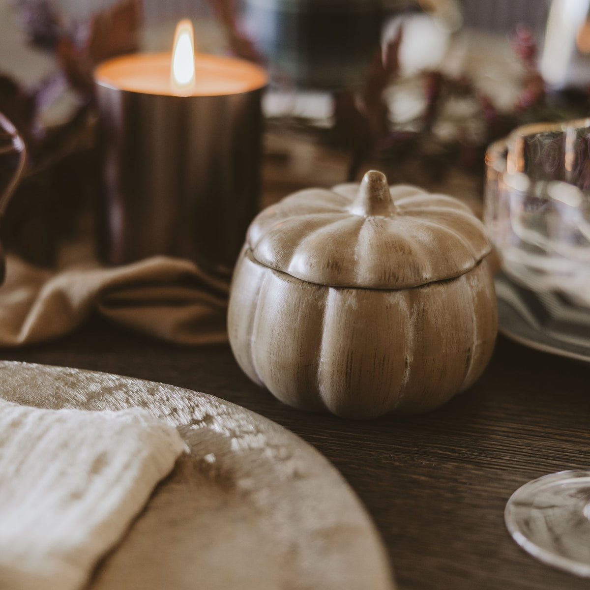 Soy candle in a ceramic pumpkin jar, 8 oz, by Sweet Water Decor, perfect for fall table decor and cozy ambiance.