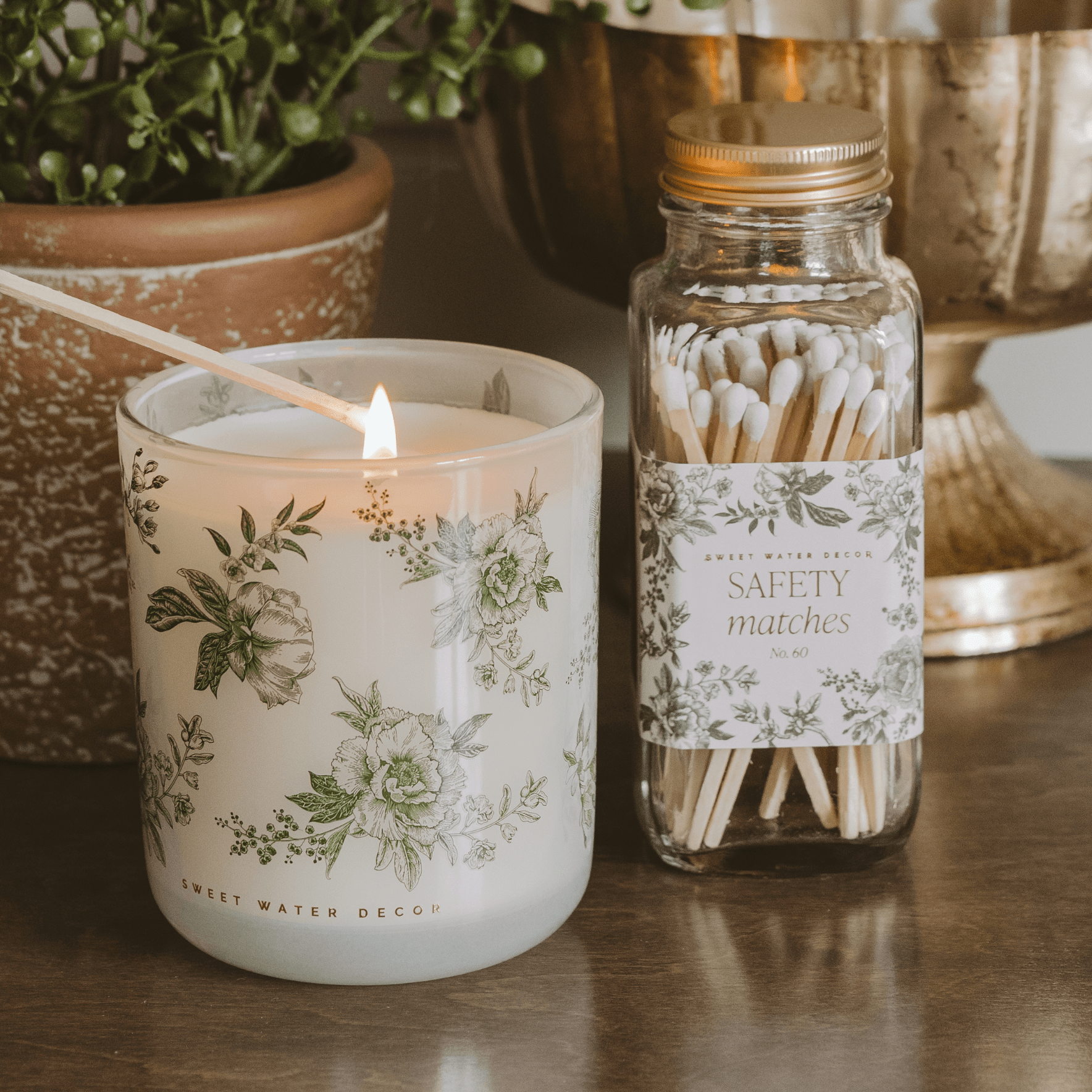 Green floral soy candle by Sweet Water Decor featuring a spring floral pattern, made with soy wax for a decorative candle.