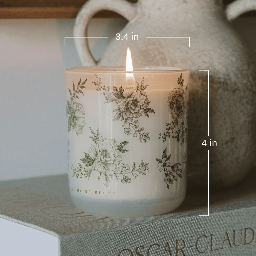 Green floral soy candle by Sweet Water Decor with lavender and sage scent, ideal for aromatherapy and relaxing ambiance.