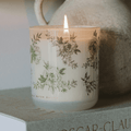 Green floral soy candle by Sweet Water Decor with lavender accents, perfect for spring home decor.