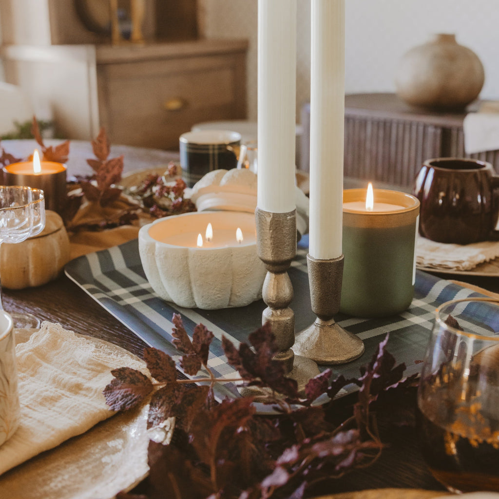 Candle in a cement pumpkin jar with cashmere and vanilla soy scent, perfect for fall table decor.