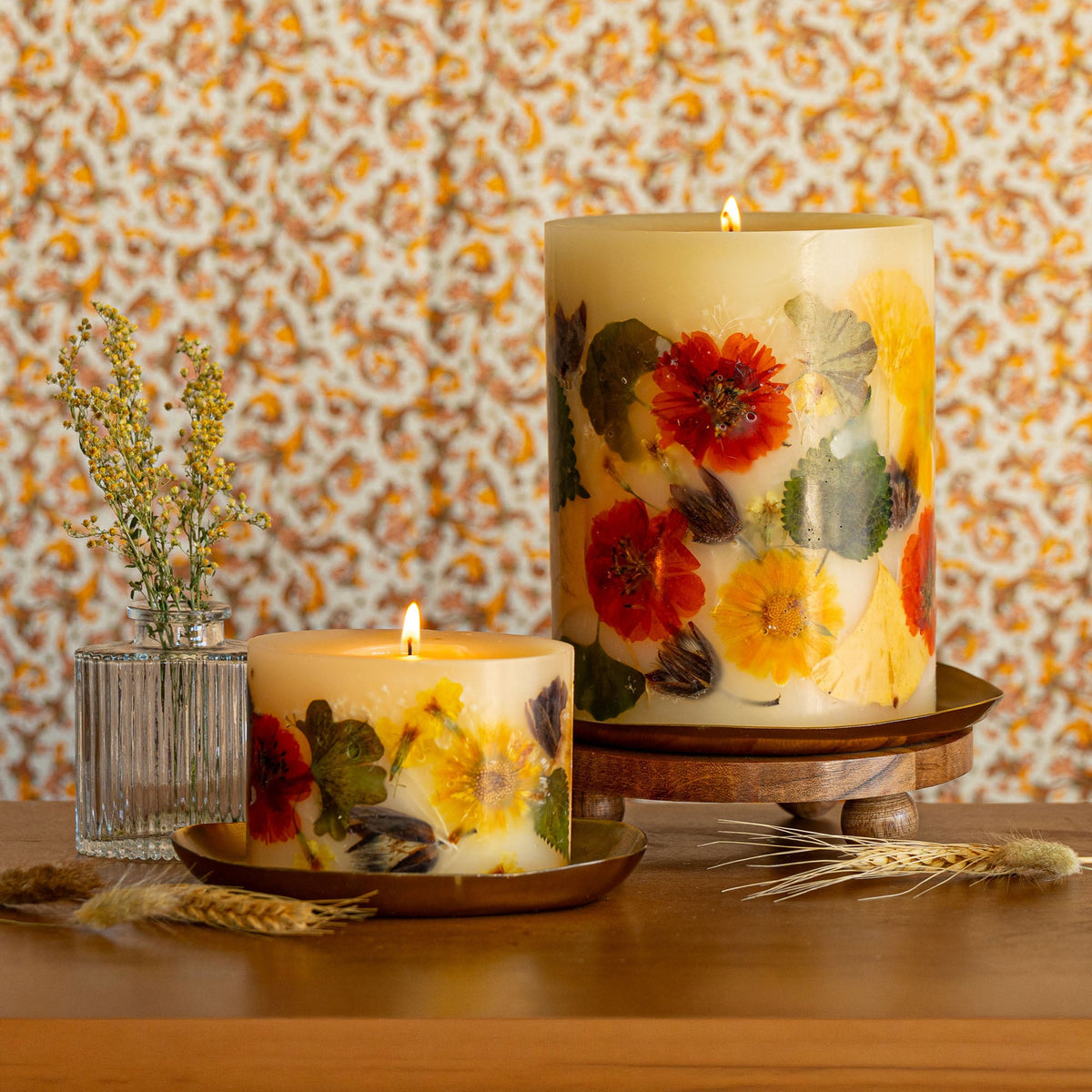Small botanical candle with harvest pumpkin design from Rosy Rings, featuring autumn-inspired botanical accents and warm candle flame.