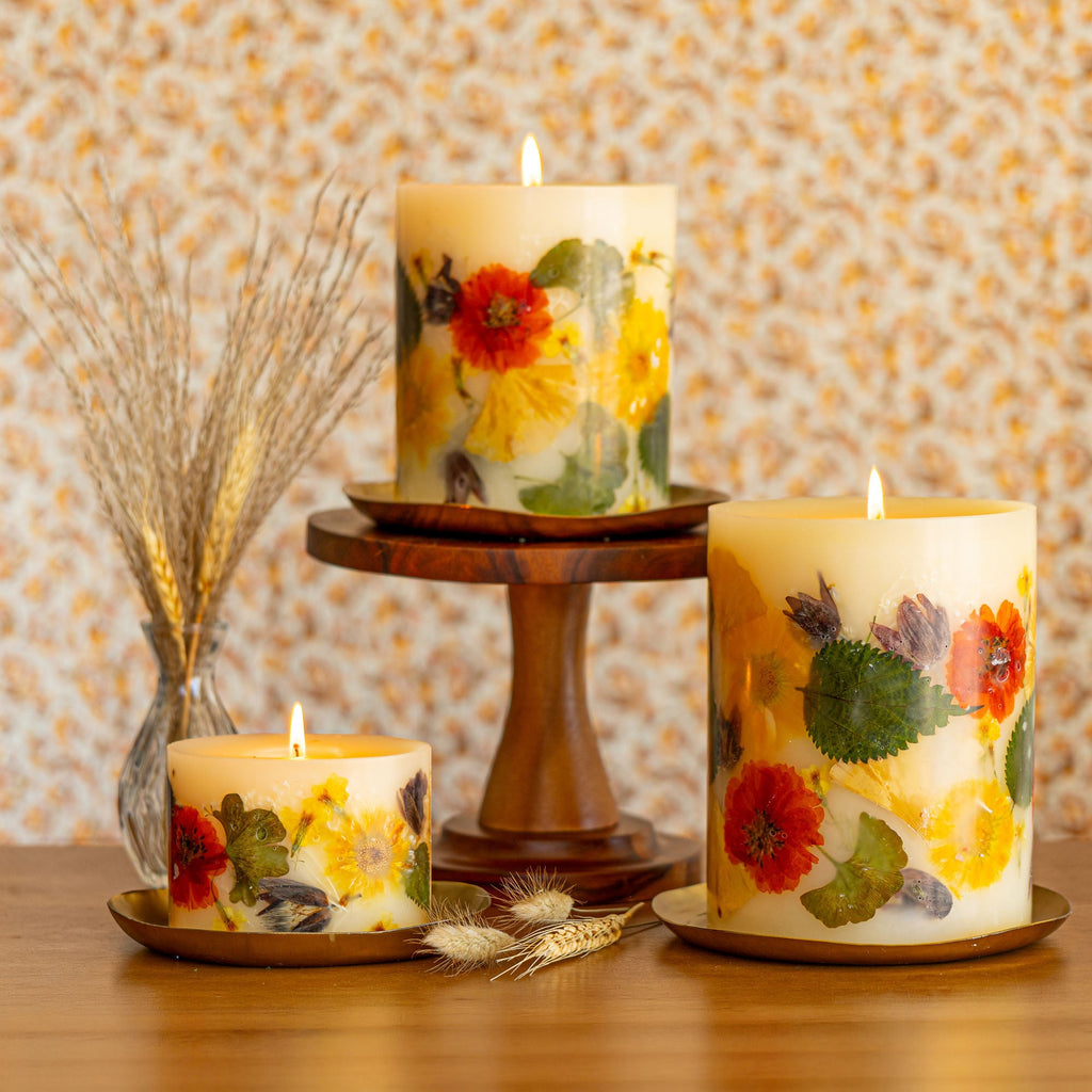 Small botanical candle by Rosy Rings featuring a harvest pumpkin design with accent botanical details.