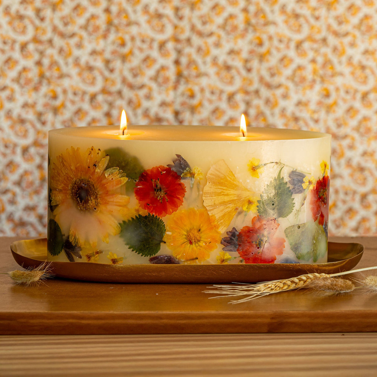Brick botanical candle by Rosy Rings featuring a Harvest Pumpkin design with vibrant botanical accents and warm autumn tones.