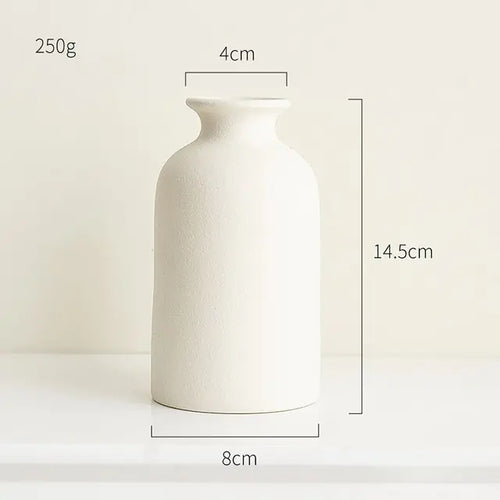 Simple ceramic vase in Nordic style with a smooth finish and neutral color, perfect for minimalistic home decor.