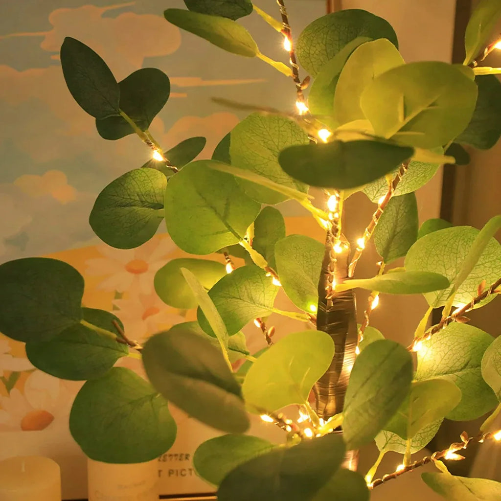 Artificial eucalyptus tree by Perfecsy with lush green leaves and realistic trunk for home or office decor.