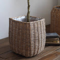 Natural wicker floor planter basket by RusticReach, ideal for home decor, showing a woven wicker basket on a wooden floor.