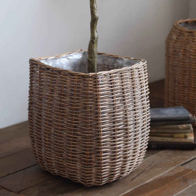 Natural wicker floor planter basket by RusticReach, ideal for home decor, showing a woven wicker basket on a wooden floor.
