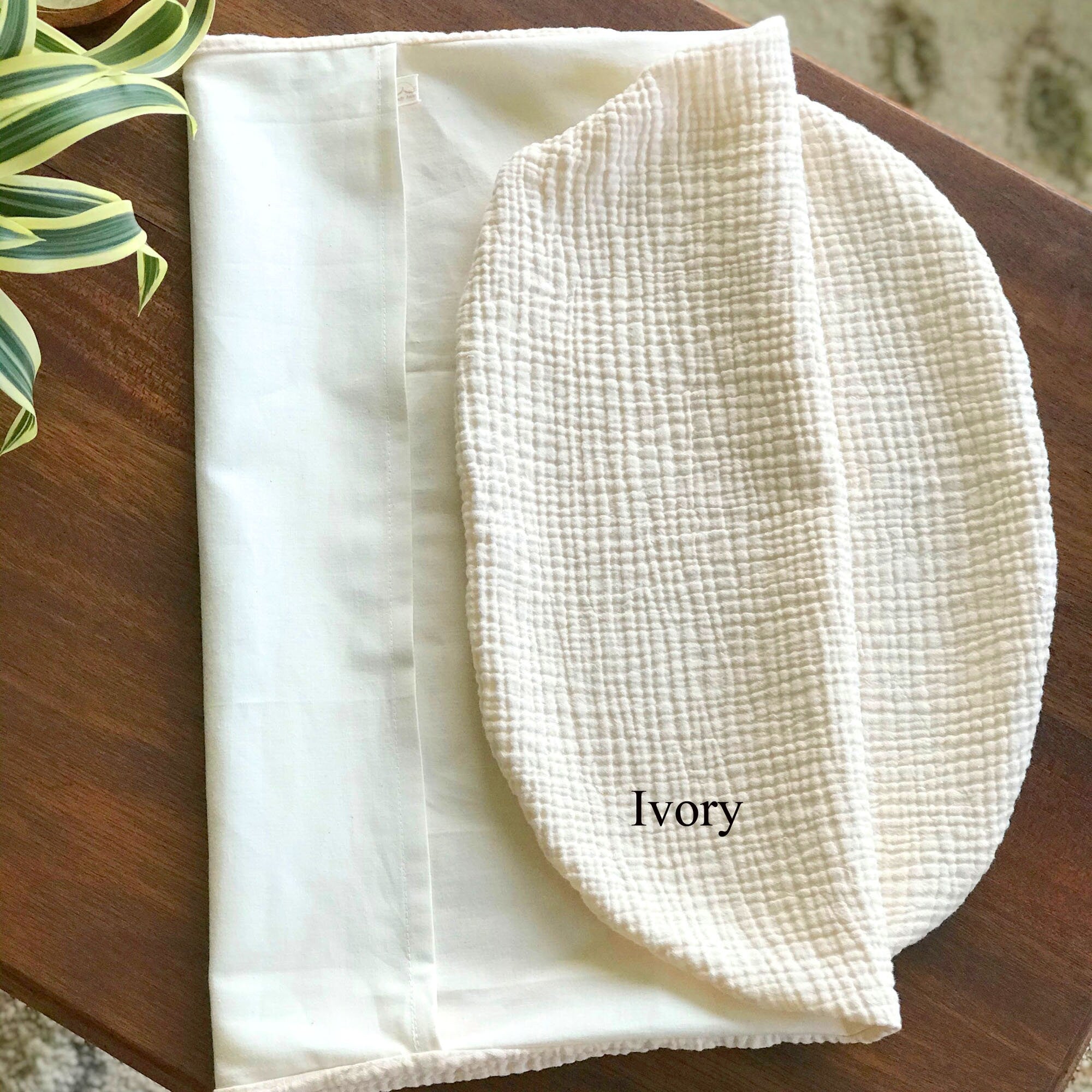 Organic cotton double gauze infant lounger slip cover by Wendy Anne, showcasing soft fabric with gentle folds and neutral tones.