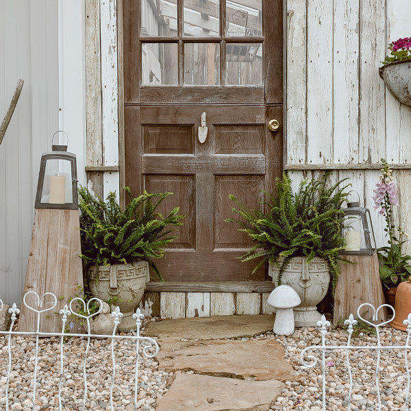 Set of two Decor Steals removable metal lanterns with wood bases, featuring glass panels and vintage style for decorative lighting.
