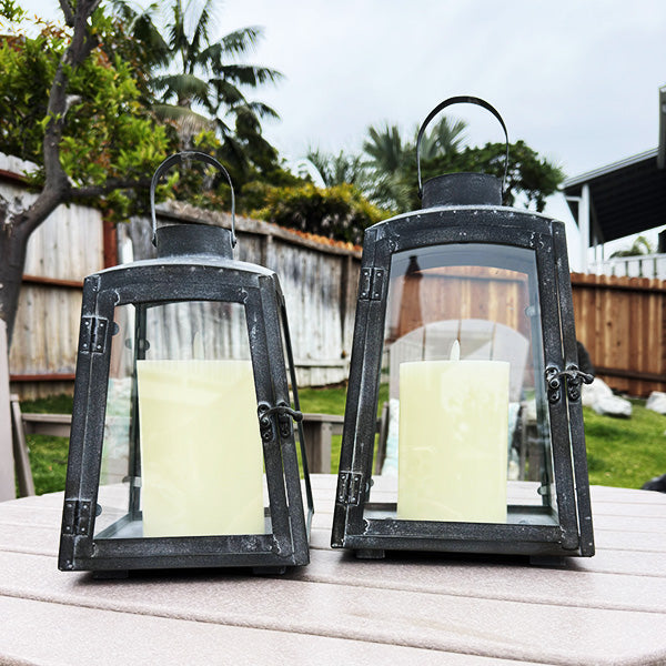 Set of two removable metal lanterns with wooden bases by Decor Steals, featuring rustic design and open frames.