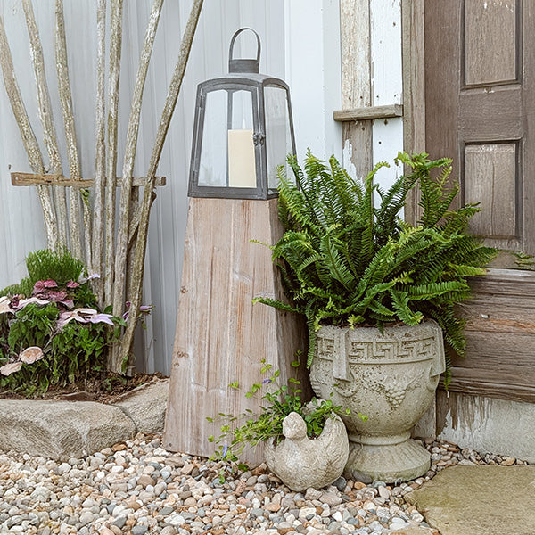 Set of two Decor Steals removable metal lanterns with wood bases, featuring rustic design and glass panels for decorative lighting.