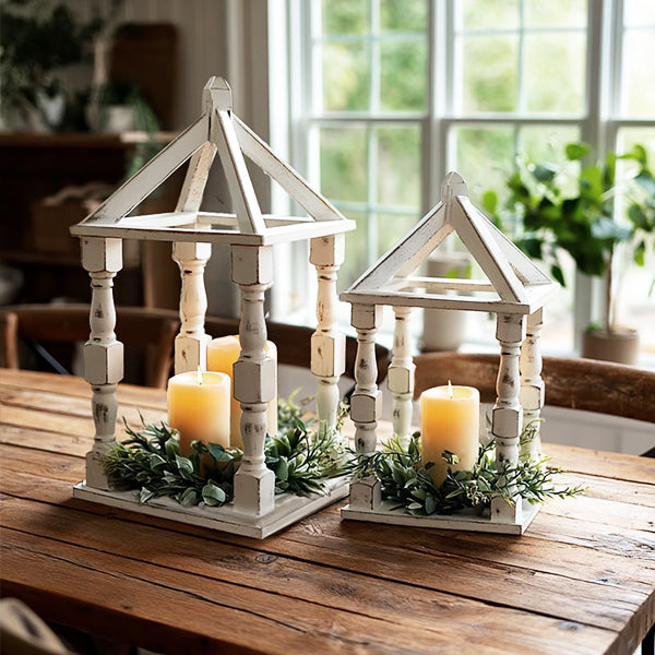 Set of two distressed white wooden turned lanterns with open sides, perfect for rustic decor or outdoor lighting.