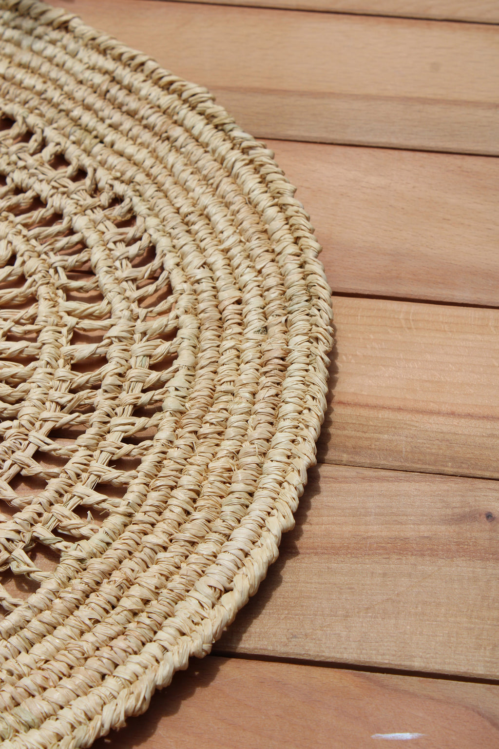 Natural woven crochet placemat from Tous Les Jours Raffia collection by Payton James, perfect for table decor.