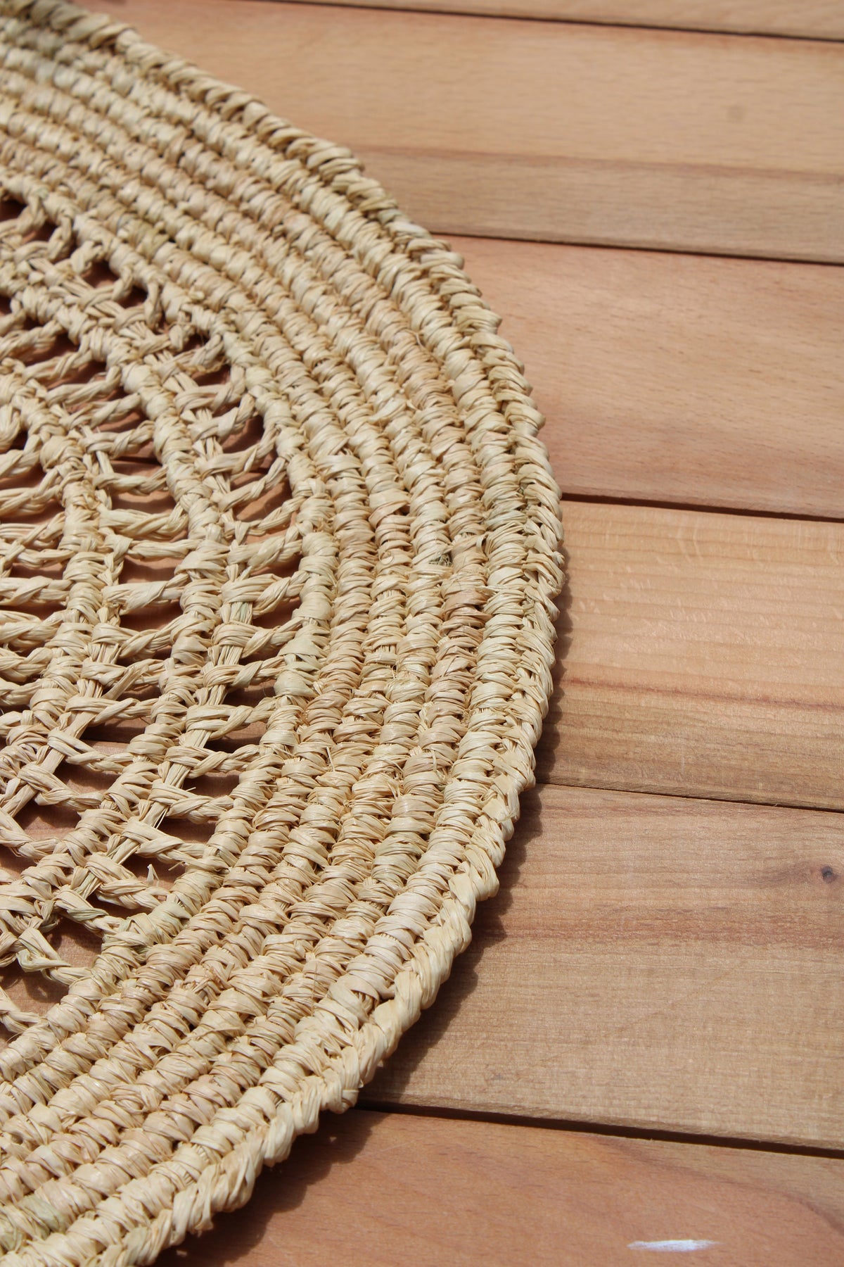 Natural woven crochet placemat from Tous Les Jours Raffia collection by Payton James, perfect for table decor.