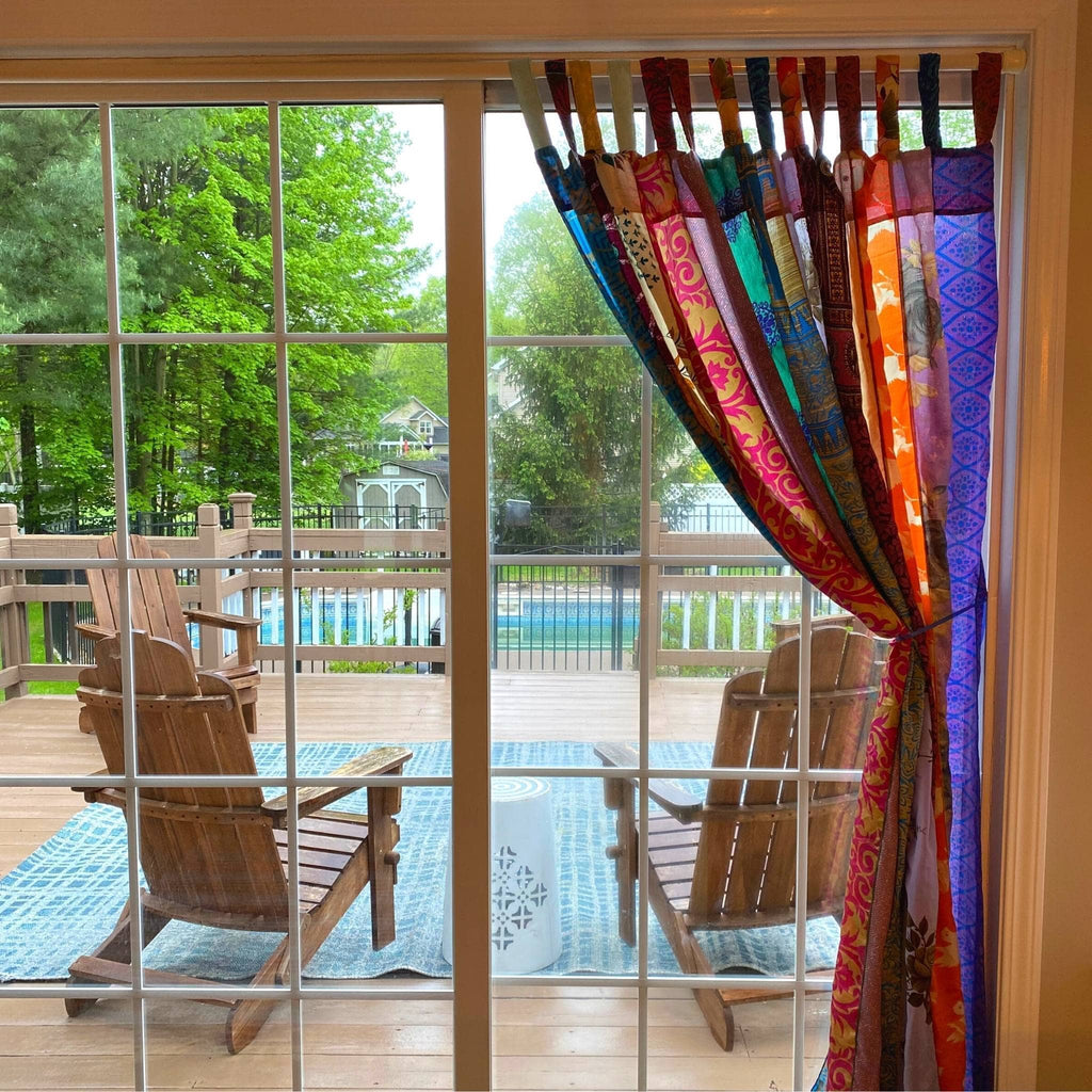 Rainbow Oasis recycled sari curtains by Darn Good Yarn, colorful boho outdoor patio decor with eco-friendly crochet and knit fabric.
