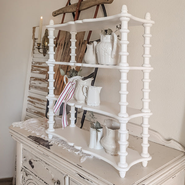 White spindle wood shelf from Decor Steals, featuring a spindle design and sturdy wooden construction for wall storage.