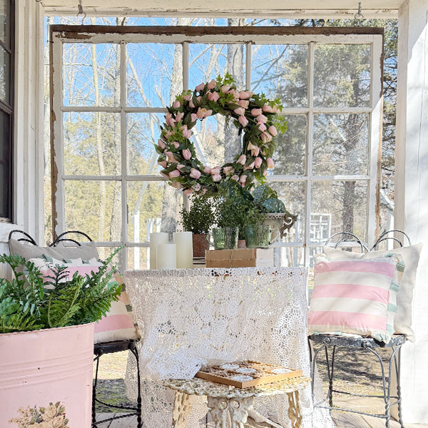 Faux soft pink tulip wreath from Decor Steals, featuring realistic pink tulips arranged in a circular floral display.